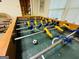 Close-up of a foosball table featuring detailed player figures and a classic green playing surface at 280 Emerald Lake Dr, Fayetteville, GA 30215