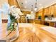 Kitchen view from table with flowers featuring wood cabinets and island at 280 Emerald Lake Dr, Fayetteville, GA 30215