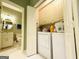 Convenient laundry area featuring a washer, dryer, and cabinets for storage at 280 Emerald Lake Dr, Fayetteville, GA 30215