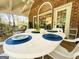 Covered outdoor dining area with seating for four and bright sunlight at 280 Emerald Lake Dr, Fayetteville, GA 30215