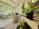 Cozy screened porch with wicker seating and potted plants, creating a relaxing outdoor space at 280 Emerald Lake Dr, Fayetteville, GA 30215
