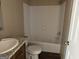 Bathroom features a white shower-tub combo and vanity with granite countertop at 436 Laurel Trce, Carrollton, GA 30116