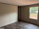 A well-lit bedroom with neutral walls and dark floors complemented by a window at 436 Laurel Trce, Carrollton, GA 30116