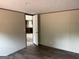Bedroom showing view into the kitchen; features neutral walls and dark floors at 436 Laurel Trce, Carrollton, GA 30116