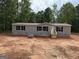 Newly constructed single-Gathering home featuring gray siding, black shutters, and surrounded by a wooded area at 436 Laurel Trce, Carrollton, GA 30116
