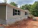 Newly constructed home featuring gray siding, black shutters, block foundation, and wooden front steps at 436 Laurel Trce, Carrollton, GA 30116