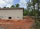 Side of the house with light brown siding and a concrete foundation at 436 Laurel Trce, Carrollton, GA 30116