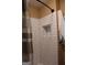 Close-up of a shower with white subway tile and a built-in niche for toiletries at 5880 Mulberry St, Austell, GA 30168