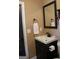 Bathroom featuring a dark vanity and black fixtures, along with a framed mirror at 5880 Mulberry St, Austell, GA 30168