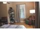 Bedroom with a bookshelf with books, a window with lots of natural light and a beautiful ceiling fan at 5880 Mulberry St, Austell, GA 30168