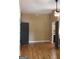Bedroom features hardwood floors and neutral paint with attached bathroom at 5880 Mulberry St, Austell, GA 30168