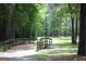 View of a walking bridge in a green area with grass and trees in Austell, Georgia at 5880 Mulberry St, Austell, GA 30168