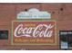 Painted Coca-Cola sign on the side of an old brick building in Austell, Georgia at 5880 Mulberry St, Austell, GA 30168