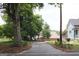 Long driveway leading up to the property, lined with landscaping and mature trees at 5880 Mulberry St, Austell, GA 30168