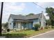 Attractive light blue home featuring a well-maintained lawn and classic architectural details at 5880 Mulberry St, Austell, GA 30168