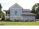 Back exterior view highlighting the siding, screened porch and well-manicured lawn at 5880 Mulberry St, Austell, GA 30168