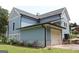View of the back of the home showing the garage, siding, and landscaping at 5880 Mulberry St, Austell, GA 30168
