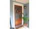 Inviting front door with a charming wreath, glass window, and a welcome mat, enhancing curb appeal at 5880 Mulberry St, Austell, GA 30168