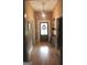 Bright hallway features gleaming hardwood floors, a stylish pendant light, and neutral wall colors at 5880 Mulberry St, Austell, GA 30168