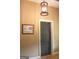 Hallway featuring a picture on the wall and a dark-colored door, complemented by neutral walls and hardwood floors at 5880 Mulberry St, Austell, GA 30168