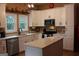Bright kitchen features white cabinetry, stainless steel appliances, and quartz countertops at 5880 Mulberry St, Austell, GA 30168