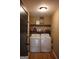 Functional laundry room featuring washer, dryer, and shelving for storage of supplies at 5880 Mulberry St, Austell, GA 30168