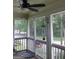 Screened patio offers an inviting spot with cozy chairs and tranquil outdoor views at 5880 Mulberry St, Austell, GA 30168
