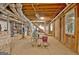 Unfinished basement with exposed framing and stairs, showing the home's potential for customization and expansion at 110 Heatherwood Dr, Fayetteville, GA 30215