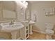 Bathroom with dual sinks, decorative mirrors, and a tiled floor at 110 Heatherwood Dr, Fayetteville, GA 30215