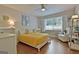 Bright bedroom with hardwood floors, a ceiling fan, and a big window at 110 Heatherwood Dr, Fayetteville, GA 30215
