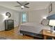 Comfortable bedroom featuring a ceiling fan, hardwood floors, and natural light at 110 Heatherwood Dr, Fayetteville, GA 30215