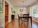Formal dining room featuring wood floors, a modern chandelier, and natural light at 110 Heatherwood Dr, Fayetteville, GA 30215