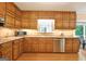 Traditional kitchen with wooden cabinets, stainless steel appliances, and a garden window at 110 Heatherwood Dr, Fayetteville, GA 30215