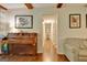 Bright living room featuring hardwood floors, piano, and doorway to the hallway at 110 Heatherwood Dr, Fayetteville, GA 30215