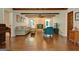 Bright living room featuring wood floors, exposed beams, and a brick fireplace at 110 Heatherwood Dr, Fayetteville, GA 30215