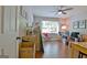 Open living room with hardwood floors, a ceiling fan, and big windows at 110 Heatherwood Dr, Fayetteville, GA 30215