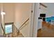 View of an unfinished stairwell leading to a finished living space with light walls, hardwood floors, and comfortable seating at 110 Heatherwood Dr, Fayetteville, GA 30215