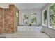 Sunroom featuring storage beneath windows and red brick accents at 110 Heatherwood Dr, Fayetteville, GA 30215