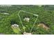 Aerial view of a secluded 5-acre lot with a stunning home nestled among lush greenery at 140 Olivia Ct, Fayetteville, GA 30215