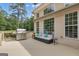Inviting back deck with grill, wicker seating, and large windows for seamless indoor-outdoor living at 140 Olivia Ct, Fayetteville, GA 30215