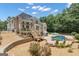 Large landscaped backyard with two-story deck, in-ground pool, and patio with furniture at 140 Olivia Ct, Fayetteville, GA 30215
