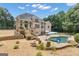 Backyard with two-story deck, patio, inground pool, landscaping and mature trees at 140 Olivia Ct, Fayetteville, GA 30215