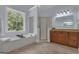 Bright bathroom features a soaking tub under a large window and a separate shower at 140 Olivia Ct, Fayetteville, GA 30215