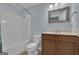 A bathroom featuring a shower-tub combination and a vanity with wood cabinets at 140 Olivia Ct, Fayetteville, GA 30215