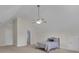 Bedroom with vaulted ceiling, fan and a view into the bathroom through an open door at 140 Olivia Ct, Fayetteville, GA 30215