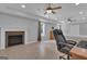 Bright bedroom featuring a charming fireplace, ceiling fan and natural light from the window at 140 Olivia Ct, Fayetteville, GA 30215