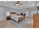 A bedroom featuring a wood bed frame, two ceiling fans, and tile floors at 140 Olivia Ct, Fayetteville, GA 30215