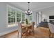 Dining area features a chandelier, hardwood floors, and natural light at 140 Olivia Ct, Fayetteville, GA 30215