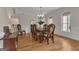 Elegant dining area with hardwood floors, chandelier, and a wooden dining table set for six at 140 Olivia Ct, Fayetteville, GA 30215