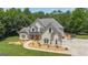 Elegant two-story home with manicured lawn, meticulous landscaping, and charming curb appeal at 140 Olivia Ct, Fayetteville, GA 30215